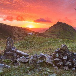 The sun rises over the horizon looking across towards Chrome Hill in the Peak District